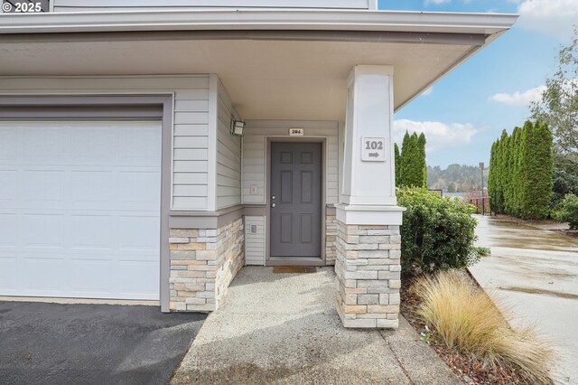 entrance to property featuring stone siding