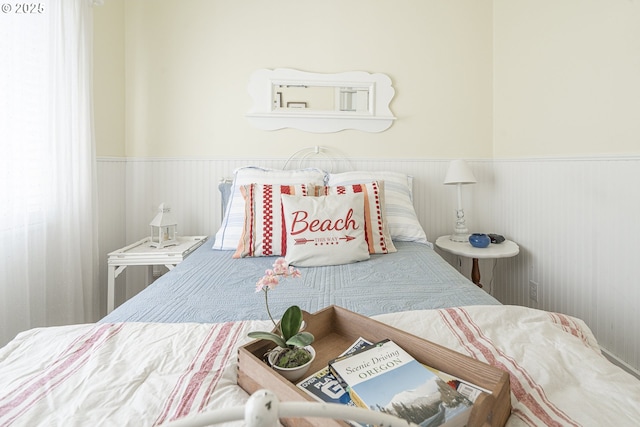 bedroom featuring wainscoting