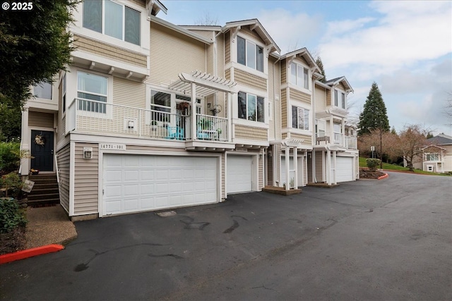 view of front facade featuring a garage, a residential view, and driveway