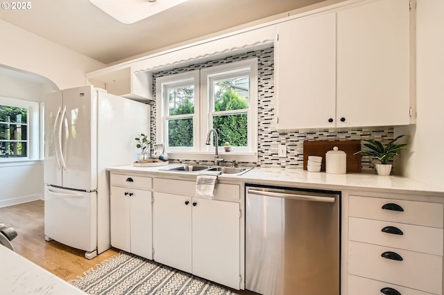 3954 NE 38th Ave, Portland, OR 97212 - kitchen featuring dishwasher, light countertops, plenty of natural light, and light wood-style flooring