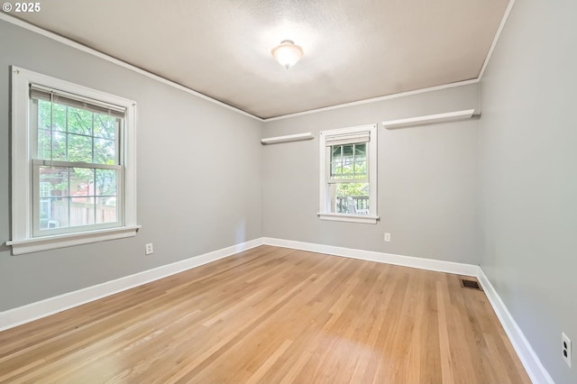 3954 NE 38th Ave, Portland, OR 97212 - empty room with healthy amount of natural light, crown molding, and light wood-style flooring