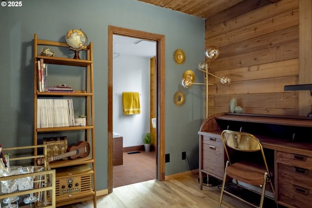 home office featuring baseboards and wood finished floors