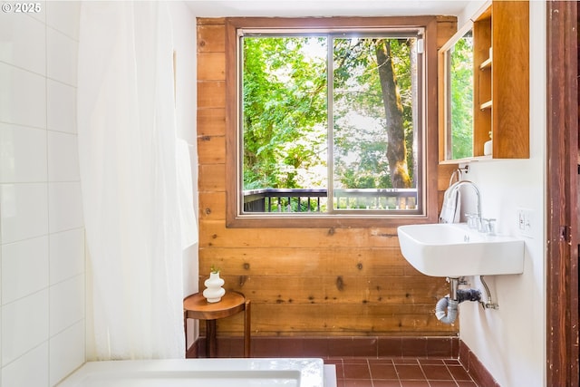 bathroom featuring wood walls