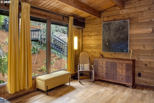 sitting room with wood walls, wooden ceiling, vaulted ceiling with beams, and wood finished floors