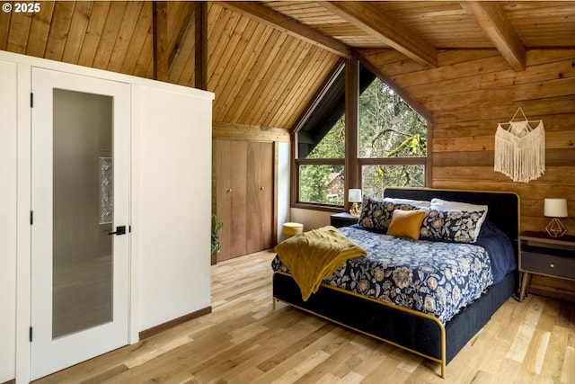 bedroom with wood walls, wooden ceiling, lofted ceiling with beams, and wood finished floors