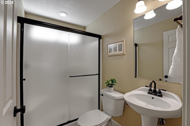 13129 NW Alvada St, Portland, OR 97229 - full bath with a shower stall, a textured ceiling, a sink, and toilet