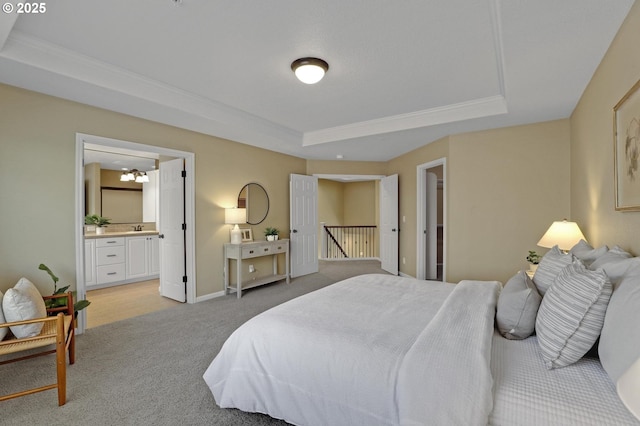 13129 NW Alvada St, Portland, OR 97229 - bedroom featuring baseboards, light carpet, ensuite bathroom, a tray ceiling, and a sink