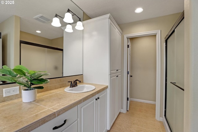 13129 NW Alvada St, Portland, OR 97229 - full bath with tasteful backsplash, vanity, visible vents, a stall shower, and tile patterned floors