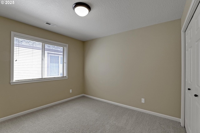 13129 NW Alvada St, Portland, OR 97229 - carpeted spare room featuring visible vents, baseboards, plenty of natural light, and a textured ceiling