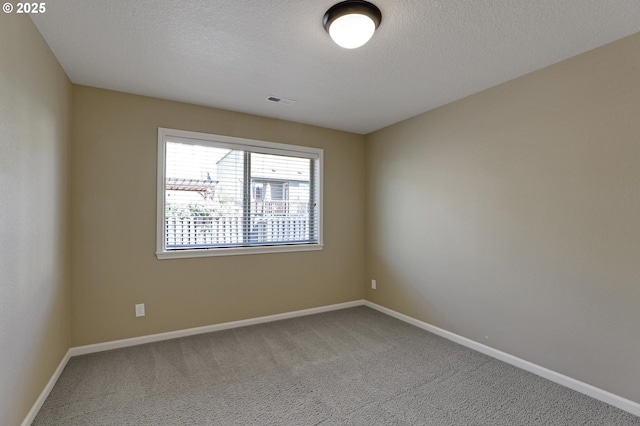 13129 NW Alvada St, Portland, OR 97229 - spare room with a textured ceiling, baseboards, visible vents, and carpet floors