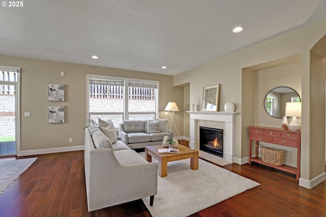 13129 NW Alvada St, Portland, OR 97229 - living room featuring dark wood-type flooring, a textured ceiling, and a fireplace