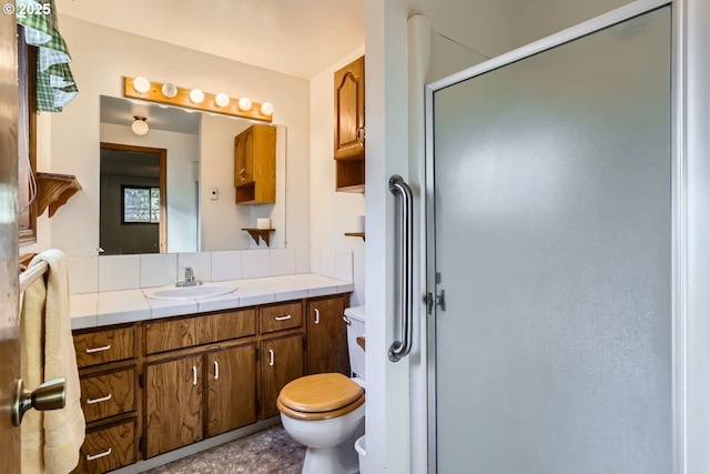 bathroom with vanity, toilet, and an enclosed shower