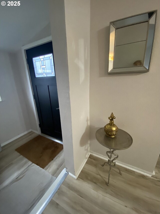 entryway featuring wood finished floors and baseboards