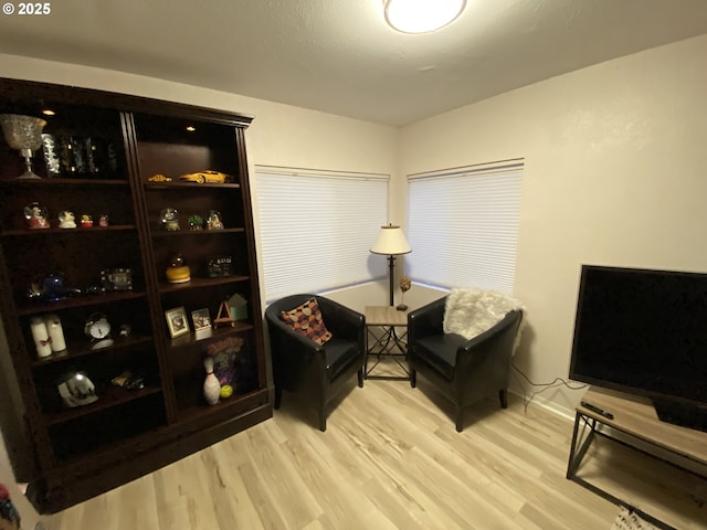 sitting room featuring wood finished floors and baseboards