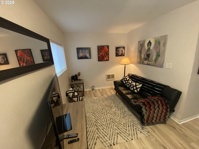 living area featuring wood finished floors and baseboards