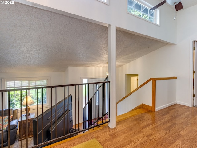 12309 SE Riveridge Dr, Vancouver, WA 98683 - stairs with wood finished floors, baseboards, a textured ceiling, and ceiling fan