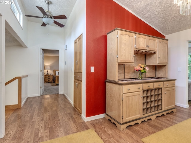 12309 SE Riveridge Dr, Vancouver, WA 98683 - kitchen with a textured ceiling, lofted ceiling, ceiling fan, light wood-type flooring, and light brown cabinetry