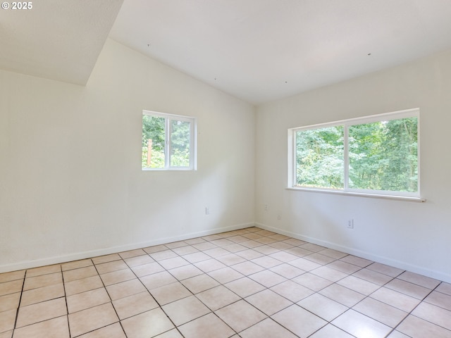 12309 SE Riveridge Dr, Vancouver, WA 98683 - spare room featuring light tile patterned flooring, lofted ceiling, and baseboards