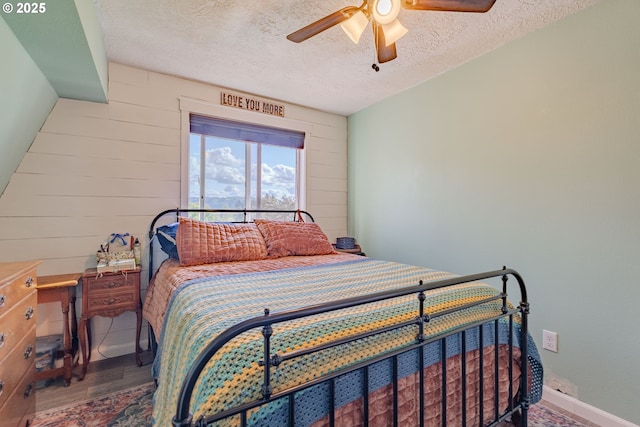 4309 C St, Washougal, WA 98671 - bedroom featuring a textured ceiling, wood finished floors, wood walls, and ceiling fan