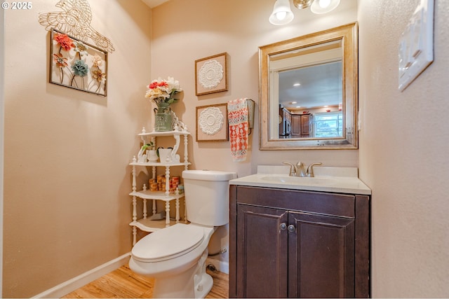 4309 C St, Washougal, WA 98671 - half bath featuring toilet, wood finished floors, baseboards, and vanity