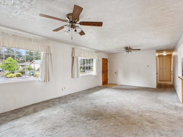 4118 SE 132nd Ave, Portland, OR 97236 - unfurnished room with plenty of natural light, a ceiling fan, a textured ceiling, and light carpet