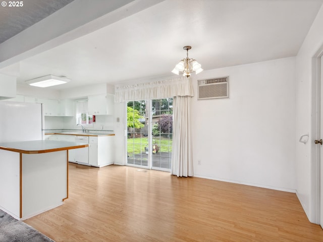 4118 SE 132nd Ave, Portland, OR 97236 - kitchen featuring dishwasher, light wood-style floors, a chandelier, white cabinetry, and an AC wall unit