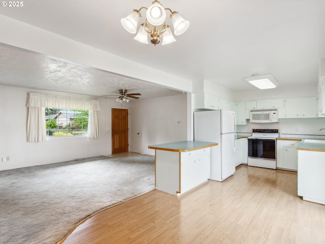 4118 SE 132nd Ave, Portland, OR 97236 - kitchen with white appliances, open floor plan, white cabinets, and light wood finished floors