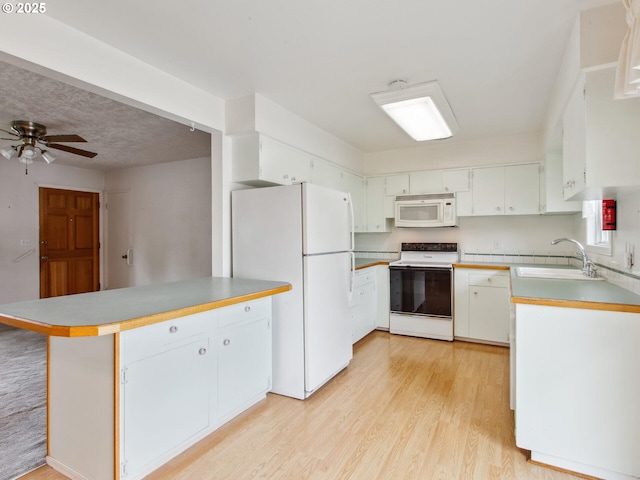 4118 SE 132nd Ave, Portland, OR 97236 - kitchen featuring white appliances, a peninsula, light wood-type flooring, a ceiling fan, and white cabinets