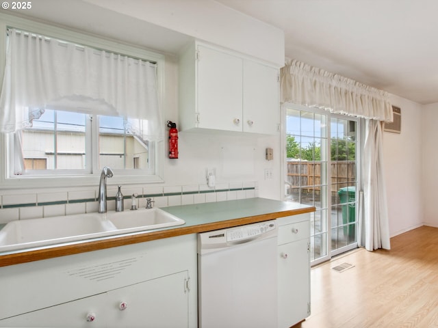 4118 SE 132nd Ave, Portland, OR 97236 - kitchen featuring white dishwasher, white cabinets, light wood-style flooring, and light countertops