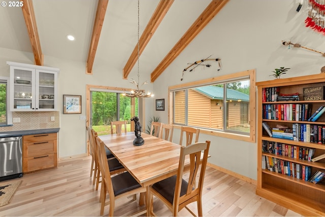 dining room featuring beamed ceiling, high vaulted ceiling, a notable chandelier, and light hardwood / wood-style flooring