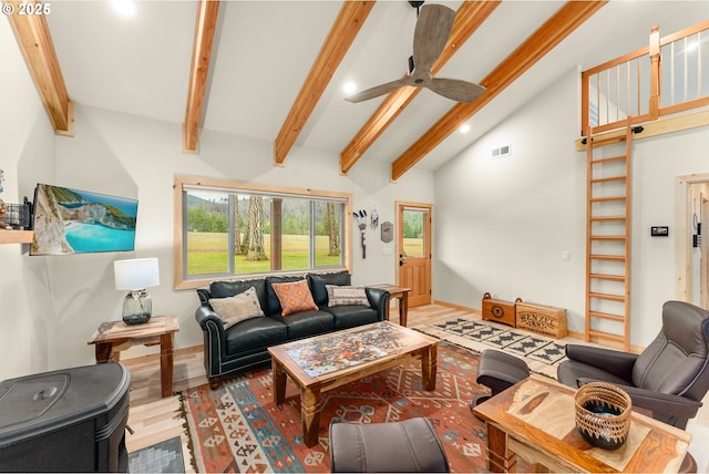 living room featuring ceiling fan, vaulted ceiling with beams, and hardwood / wood-style flooring