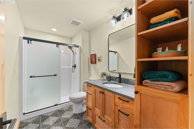 bathroom with toilet, walk in shower, and vanity