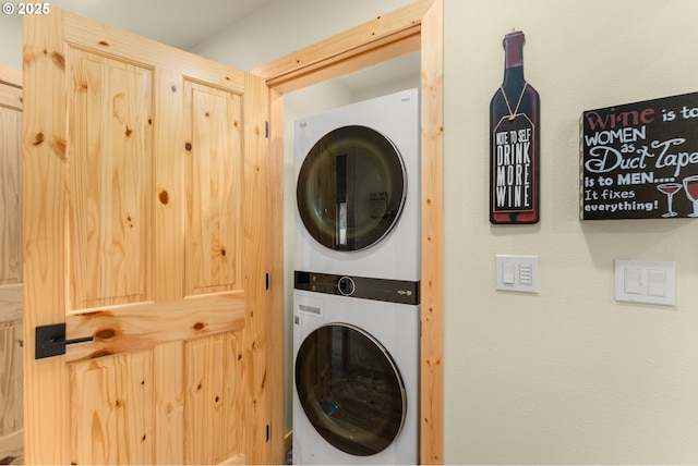 washroom with stacked washer / drying machine