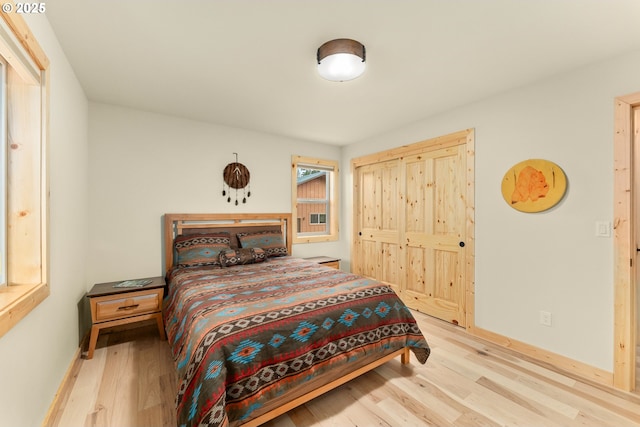 bedroom featuring light hardwood / wood-style floors and a closet