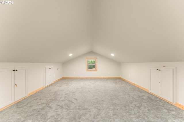 bonus room with carpet floors and vaulted ceiling