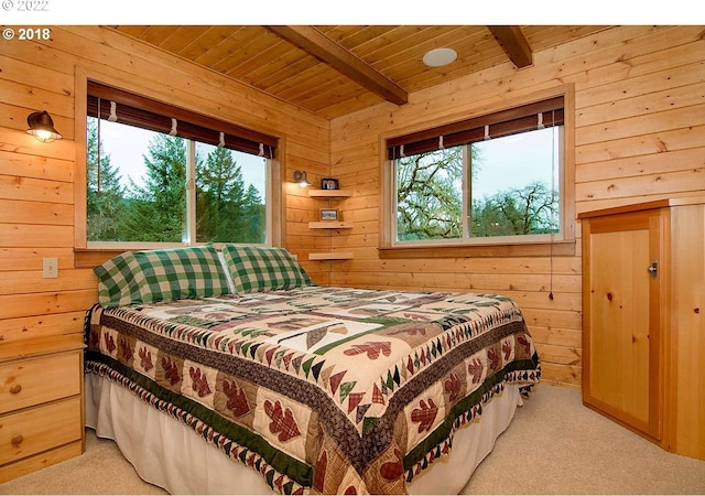 bedroom featuring wooden walls and multiple windows