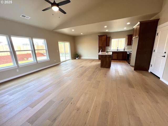 931 Medina Ave, Sutherlin, OR 97479 - unfurnished living room featuring a wealth of natural light, light wood finished floors, visible vents, and ceiling fan