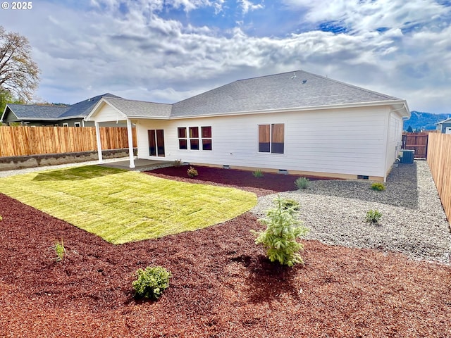 931 Medina Ave, Sutherlin, OR 97479 - back of property featuring a patio, roof with shingles, crawl space, and a fenced backyard