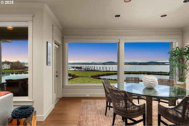 sunroom / solarium with a water view and plenty of natural light