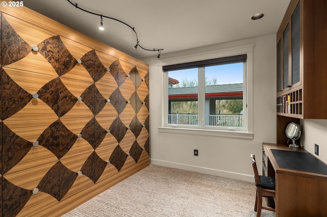 office area featuring track lighting, carpet flooring, and baseboards