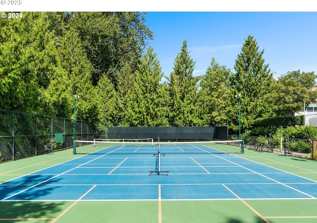 view of sport court featuring fence