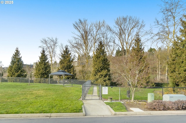 view of home's community featuring a gazebo, a gate, fence, and a yard