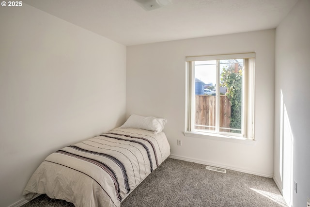 carpeted bedroom with visible vents and baseboards