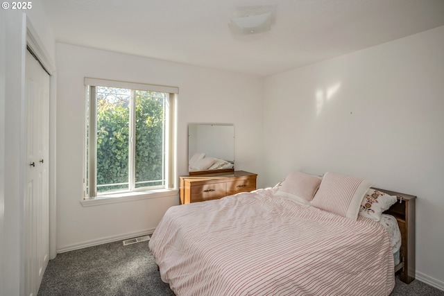 bedroom with visible vents, multiple windows, and carpet