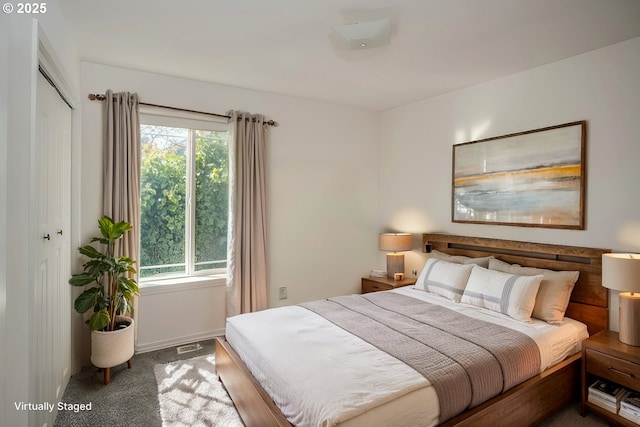 bedroom with a closet, baseboards, visible vents, and carpet flooring