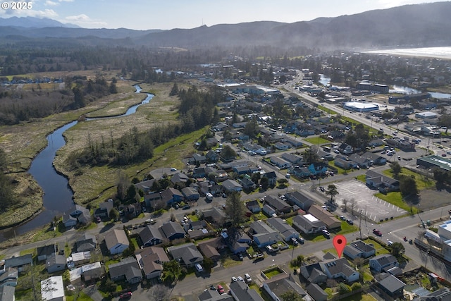 aerial view featuring a water and mountain view