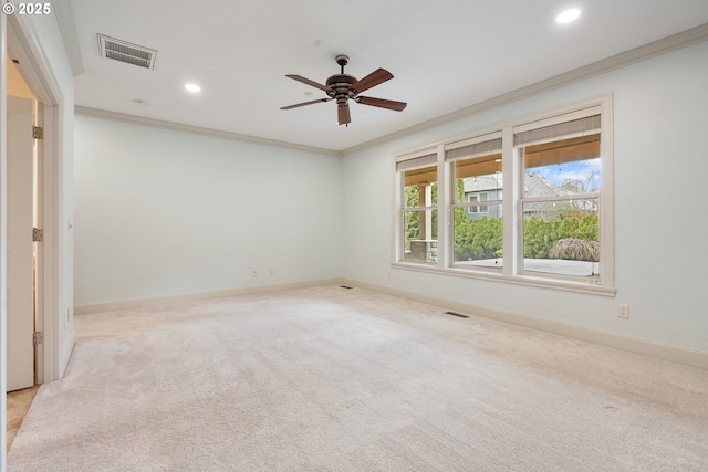 empty room featuring ornamental molding, visible vents, and baseboards