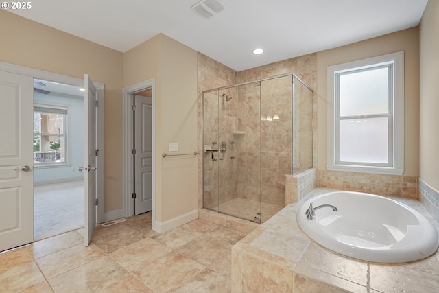 full bath with a garden tub, a shower stall, baseboards, and a wealth of natural light