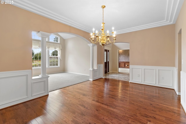 4220 NE 171st Ave, Vancouver, WA 98682 - unfurnished dining area with arched walkways, a chandelier, hardwood / wood-style floors, wainscoting, and decorative columns