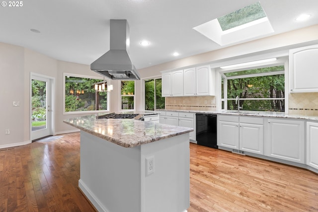 4220 NE 171st Ave, Vancouver, WA 98682 - kitchen with black dishwasher, island range hood, decorative backsplash, light stone countertops, and recessed lighting